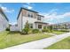 Charming two-story home featuring a well-manicured lawn and landscape at 8573 Lamppost Ln, Orlando, FL 32832