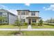 Charming two-story home with a well-manicured lawn and beautiful landscaping at 8573 Lamppost Ln, Orlando, FL 32832