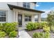 Inviting front porch with decorative pillars and manicured landscaping at 8573 Lamppost Ln, Orlando, FL 32832