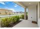 Covered front porch showing a view of the neighborhood street at 8573 Lamppost Ln, Orlando, FL 32832