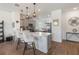Bright kitchen boasts stylish pendant lighting, grey cabinets, and a breakfast bar at 8573 Lamppost Ln, Orlando, FL 32832