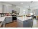 Charming kitchen with grey cabinets, modern appliances, and adjacent dining area at 8573 Lamppost Ln, Orlando, FL 32832