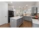 Open concept kitchen featuring an island, stainless steel appliances, and wood floors at 8573 Lamppost Ln, Orlando, FL 32832