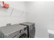 This functional laundry room features modern washer and dryer units with a storage shelf above at 8573 Lamppost Ln, Orlando, FL 32832