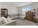 Cozy living room with a comfortable sectional sofa, natural light, and a vintage cabinet at 8573 Lamppost Ln, Orlando, FL 32832