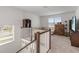 Upstairs loft area with comfortable seating, a large TV, and plenty of natural light at 8573 Lamppost Ln, Orlando, FL 32832