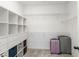 Spacious walk-in closet with custom shelving and ample storage space, complete with luggage at 8573 Lamppost Ln, Orlando, FL 32832