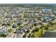 Aerial view of a community with beautiful homes, picturesque lakes, and lush landscaping at 8665 Theiler St, Orlando, FL 32827