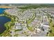 Stunning aerial view of a community with a picturesque lake, lush trees, and neatly arranged homes at 8665 Theiler St, Orlando, FL 32827