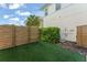This backyard shows artificial turf and a privacy fence, creating a clean outdoor space at 8665 Theiler St, Orlando, FL 32827