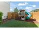 Fun backyard play area with a slide and playhouse for outdoor enjoyment at 8665 Theiler St, Orlando, FL 32827