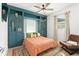 Comfortable bedroom with built-in teal cabinetry and a full size bed and chair at 8665 Theiler St, Orlando, FL 32827