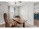 Bright bedroom with a comfortable chair and a wooden desk with an adjustable height at 8665 Theiler St, Orlando, FL 32827