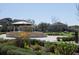 Landscaped community park with a fountain, seating area, and sidewalks within the residential community at 8665 Theiler St, Orlando, FL 32827