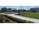 Picturesque community park featuring a decorative fountain, lush landscaping, and walking paths at 8665 Theiler St, Orlando, FL 32827