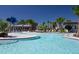 Resort-style community pool with a splash zone, palm trees, and plenty of seating at 8665 Theiler St, Orlando, FL 32827