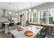 Bright dining area with modern lighting, stylish wallpaper, and access to the backyard at 8665 Theiler St, Orlando, FL 32827