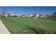 Expansive green space in a residential community with manicured lawns, inviting gazebos, and colorful houses in the background at 8665 Theiler St, Orlando, FL 32827