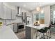Modern kitchen with gray cabinetry, stainless steel appliances, and a center island at 8665 Theiler St, Orlando, FL 32827