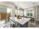 This kitchen showcases a bright interior with a kitchen island, stainless steel appliances, and views into the dining room at 8665 Theiler St, Orlando, FL 32827