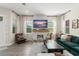 Spacious living room with a modern fireplace, large windows, and comfortable furnishings at 8665 Theiler St, Orlando, FL 32827