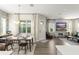 Open-concept living room with a dining area, fireplace, and stylish decor at 8665 Theiler St, Orlando, FL 32827