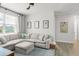 Spacious living room with a large sectional sofa, neutral colors, ample natural light, and stylish décor at 8665 Theiler St, Orlando, FL 32827