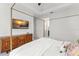 Comfortable main bedroom with a large screen TV and a stylish wood dresser at 8665 Theiler St, Orlando, FL 32827