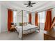 This main bedroom features a four-poster bed, tray ceiling, and decorative curtains at 8665 Theiler St, Orlando, FL 32827