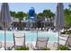 Resort-style pool area features a water bucket, palm trees, water features, and lounge chairs for residents enjoyment at 8665 Theiler St, Orlando, FL 32827