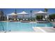 Gorgeous swimming pool features upscale lounge seating, sunshades, and clear blue water to enjoy the sunshine at 8665 Theiler St, Orlando, FL 32827