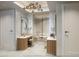 Bright bathroom featuring a vanity, a glass-enclosed shower, and a stylish chandelier at 10160 Autumn Mist Ln # 601, Golden Oak, FL 32836
