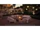 Outdoor lounge area with a fire pit, comfortable seating, and ambient lighting for evening relaxation at 10160 Autumn Mist Ln # 601, Golden Oak, FL 32836