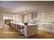 Modern, white kitchen featuring an island with seating, stainless steel appliances, and marble countertops at 10160 Autumn Mist Ln # 601, Golden Oak, FL 32836