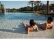 Relaxing by the pool with sparkling water, palm trees, and resort-style amenities at 10160 Autumn Mist Ln # 601, Golden Oak, FL 32836
