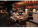 Diners enjoying the restaurant with a view of the kitchen and unique red light fixtures at 10160 Autumn Mist Ln # 601, Golden Oak, FL 32836