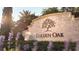Stone community sign for Golden Oak amidst green landscaping and blooming purple flowers at 10160 Autumn Mist Ln # 601, Golden Oak, FL 32836