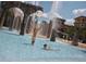 Fun waterpark featuring stone arches, fountains, and children playing with a beach ball at 10160 Autumn Mist Ln # 601, Golden Oak, FL 32836