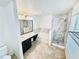 Modern bathroom featuring a marble tiled shower and separate tub and double sink vanity with black cabinets at 1053 Tourmaline Dr, Kissimmee, FL 34746