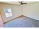 Spacious empty bedroom featuring new carpet, a ceiling fan, and a window with natural light at 1053 Tourmaline Dr, Kissimmee, FL 34746