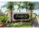 Welcoming entrance to Crystal Cove Resort with lush landscaping and swaying palm trees at 1053 Tourmaline Dr, Kissimmee, FL 34746