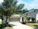 Attractive single-story home with a well-maintained yard, a driveway, and a two-car garage at 1053 Tourmaline Dr, Kissimmee, FL 34746