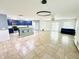 Open-concept living space featuring modern light fixtures, tile floors, and kitchen with an island at 1053 Tourmaline Dr, Kissimmee, FL 34746