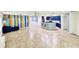 Bright, open-concept living space with a dining area, tile flooring, and modern lighting at 1053 Tourmaline Dr, Kissimmee, FL 34746