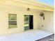 Covered patio with view of the yard featuring a ceiling fan, wind chimes and access to the house through sliding glass doors at 1053 Tourmaline Dr, Kissimmee, FL 34746