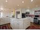 Gourmet kitchen boasts white cabinetry, island, and modern appliances for a culinary enthusiast's dream at 1110 W Ivanhoe Blvd # 15, Orlando, FL 32804