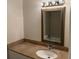 Bathroom featuring granite countertop, modern vanity and stylish mirror at 11574 Westwood Blvd # 1126, Orlando, FL 32821