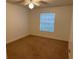 Bedroom featuring neutral paint, carpet flooring, a ceiling fan, and a window at 11574 Westwood Blvd # 1126, Orlando, FL 32821