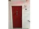 Inviting red front door with decorative knocker and convenient key lockbox at 11574 Westwood Blvd # 1126, Orlando, FL 32821