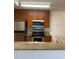 Kitchen with stainless steel appliances, granite countertops, and wooden cabinets at 11574 Westwood Blvd # 1126, Orlando, FL 32821